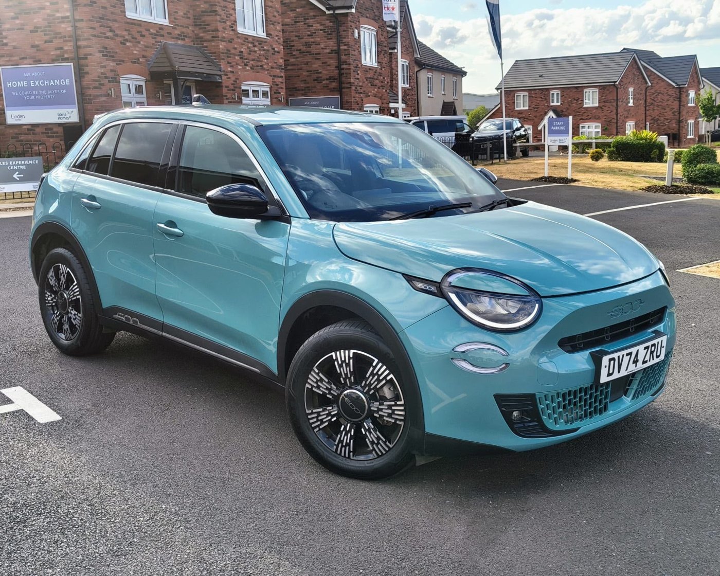 Repaired and polished light blue Fiat 600 outside the workshop